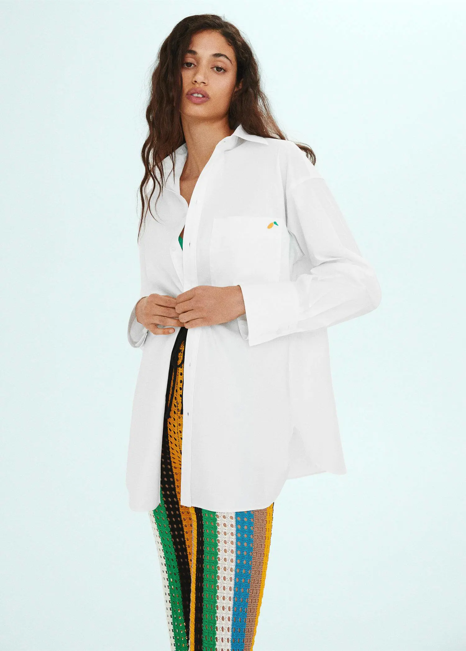Mango Oversized shirt with embroidered detail. a woman in a white lab coat holding onto a black belt. 