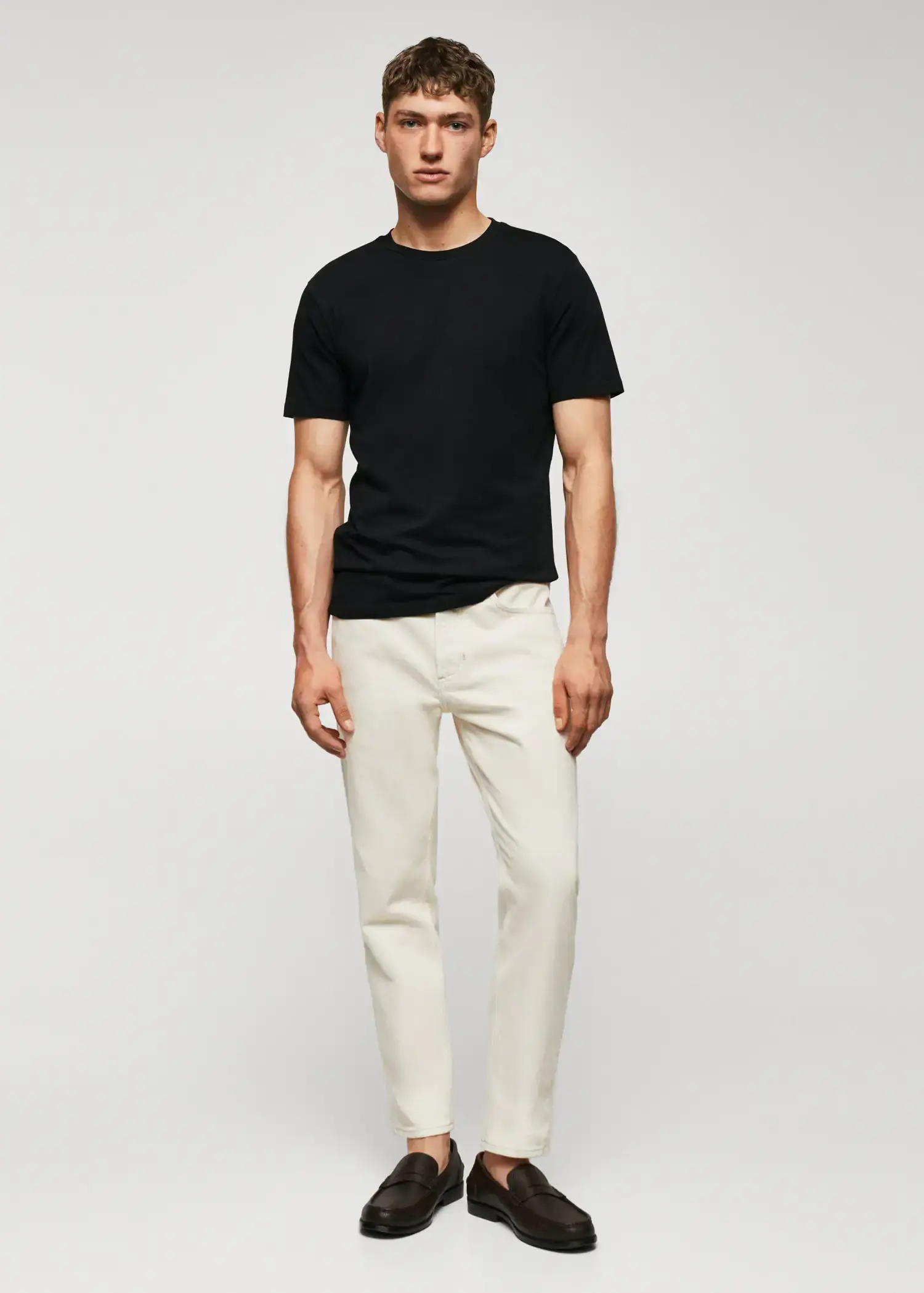 Mango Basic lightweight cotton t-shirt. a man wearing white pants and a black t-shirt. 