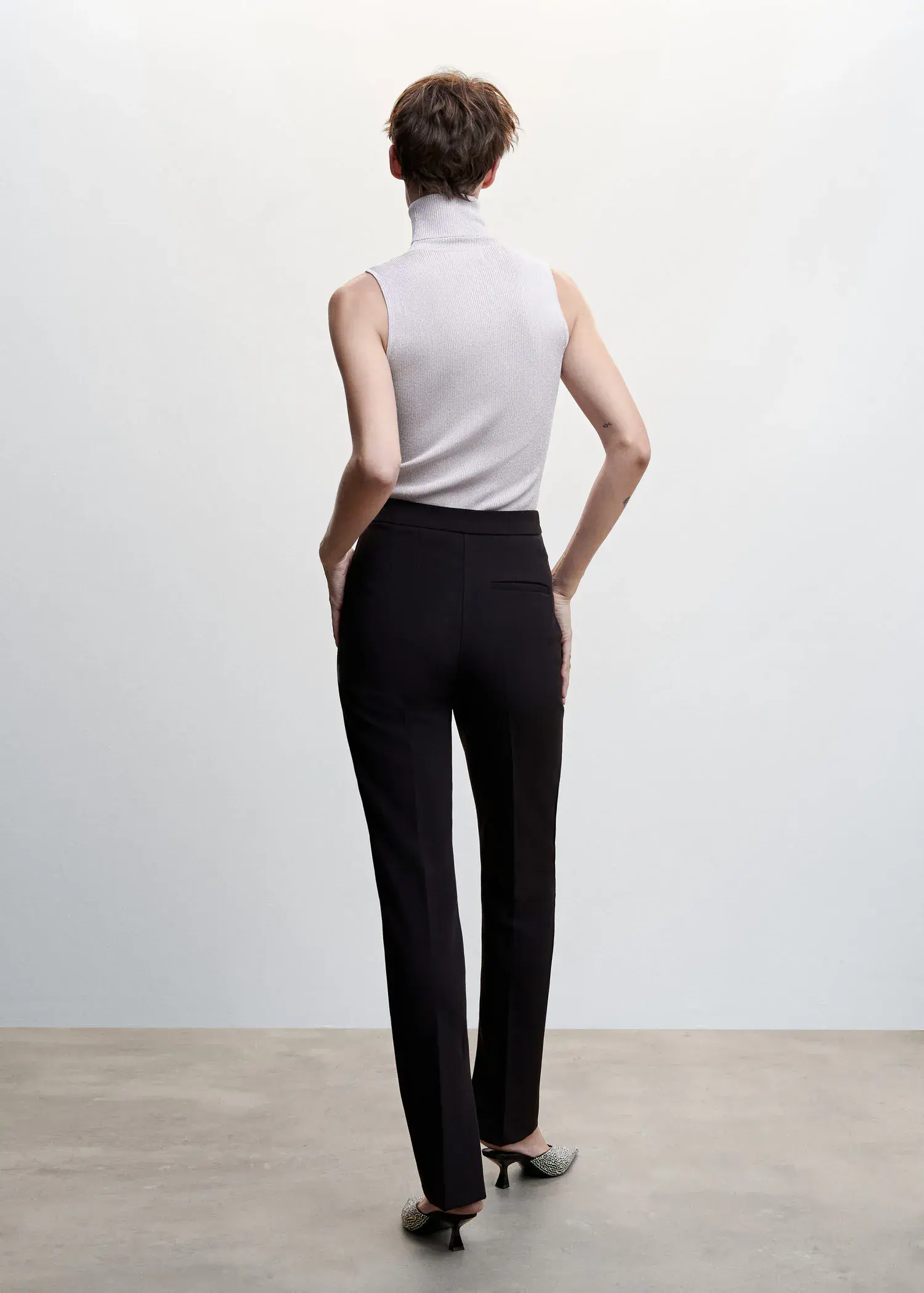 Mango Turtleneck knit top. a woman in a white shirt and black pants. 