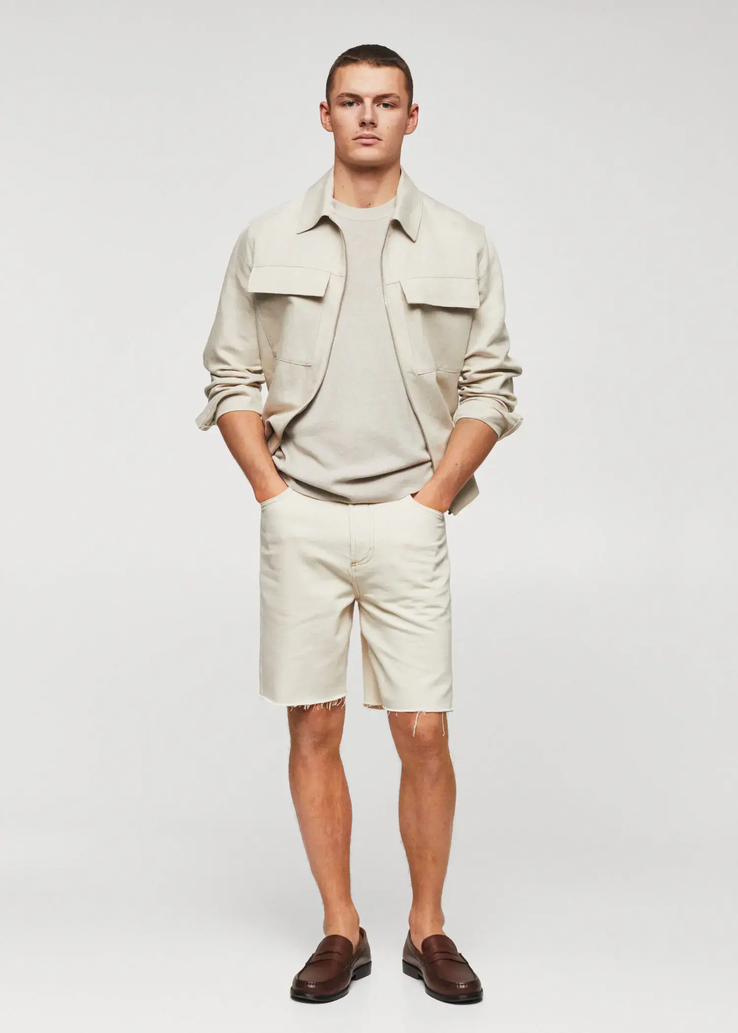 Mango Cotton fine-knit t-shirt. a man in a tan jacket and white shorts. 