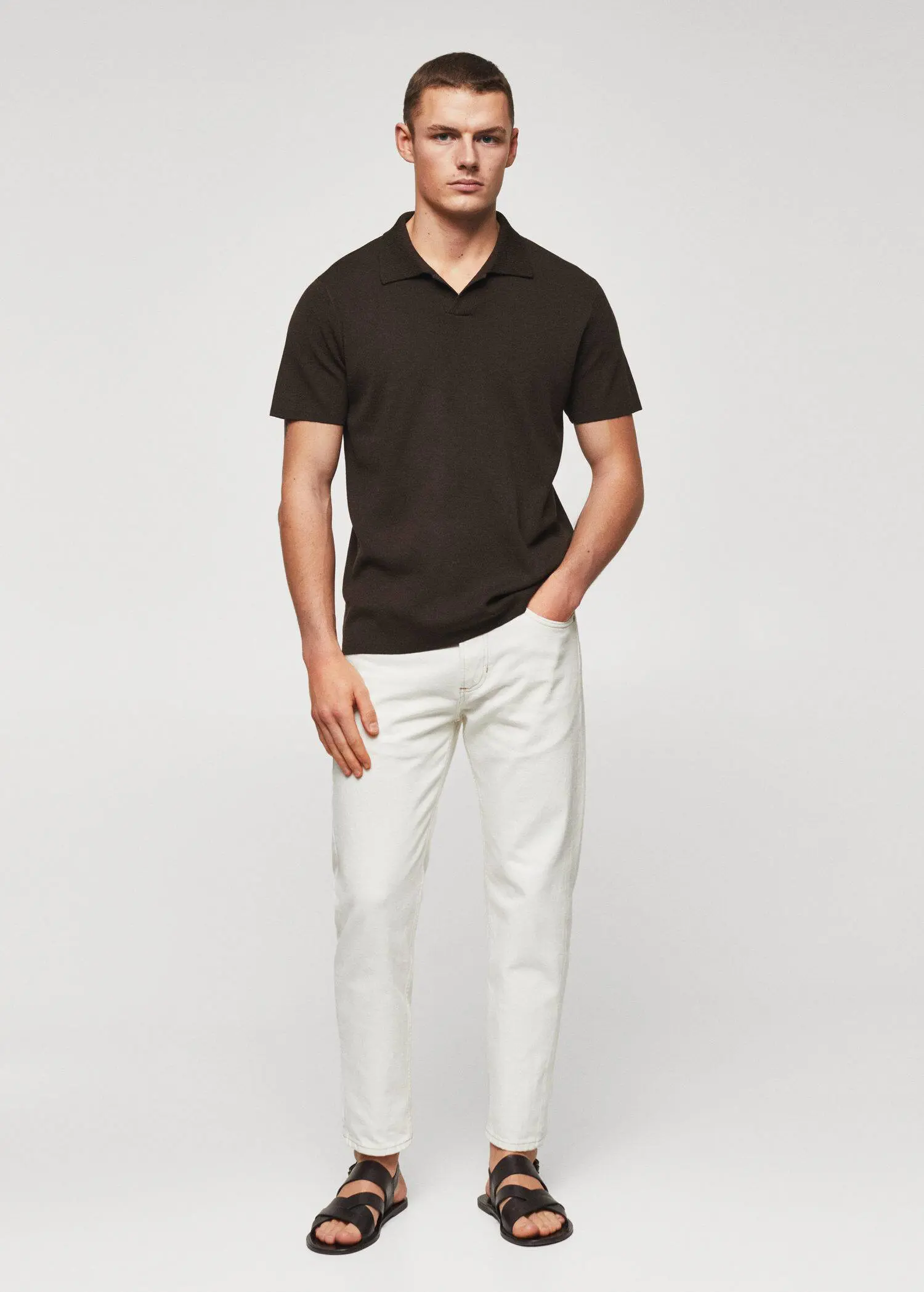 Mango Fine-knit polo shirt. a man wearing white pants and a black shirt. 