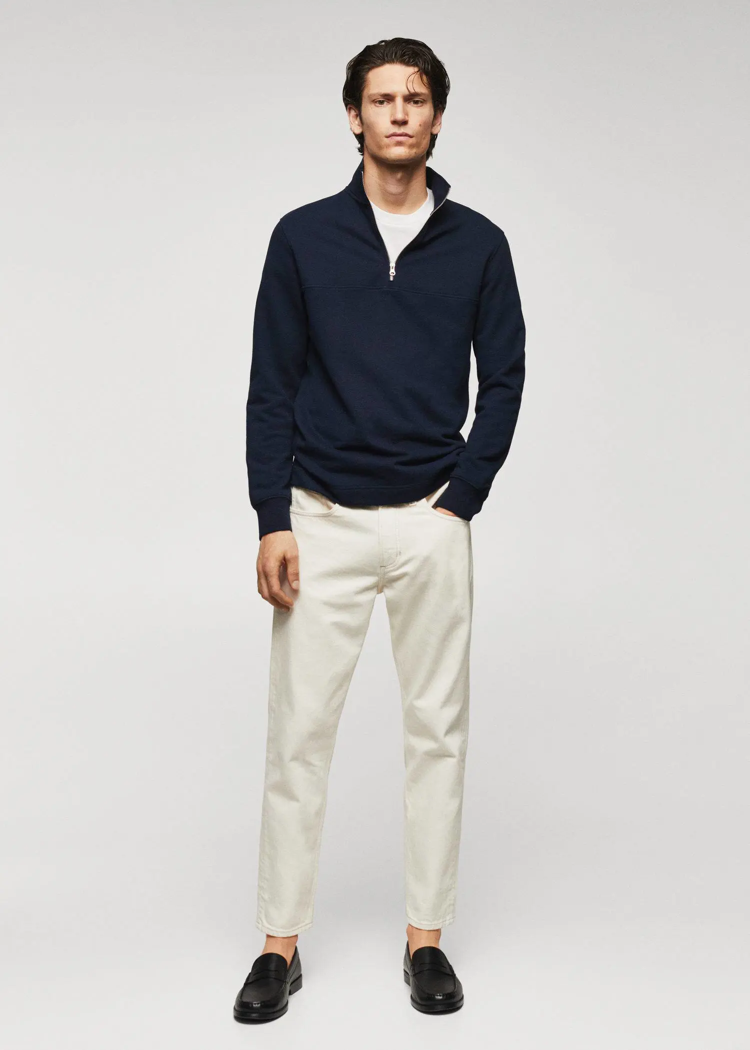 Mango Cotton sweatshirt with zipper neck. a man in a navy blue sweater and white pants. 