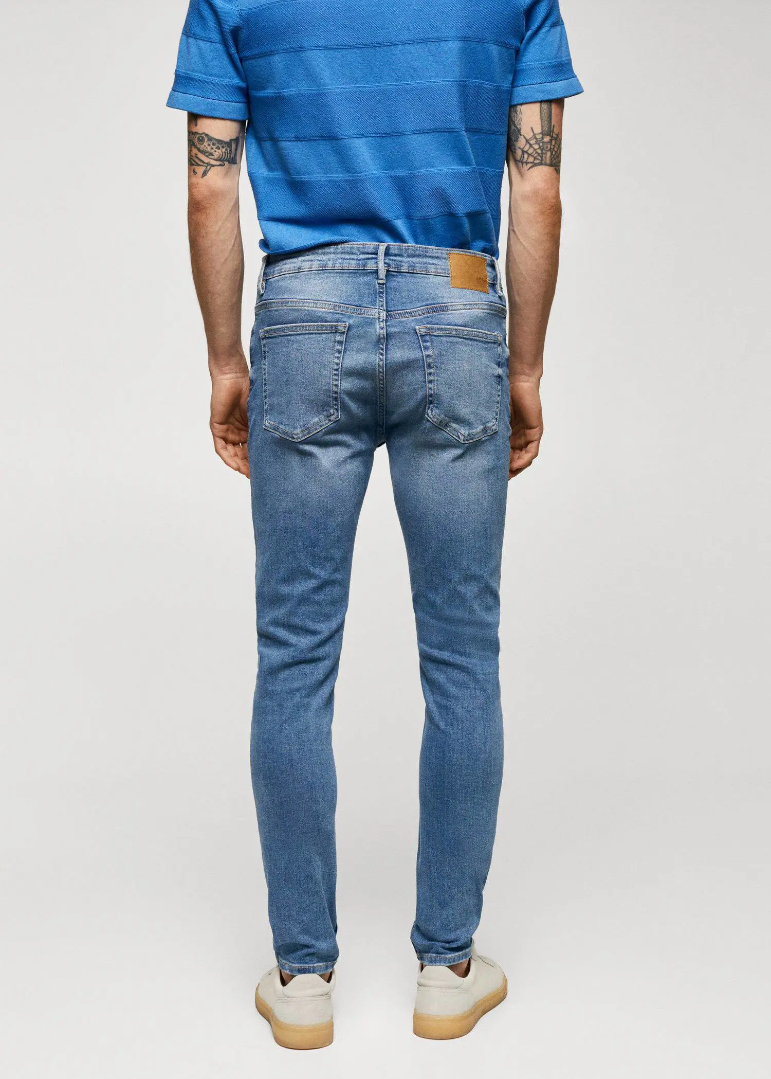 Mango Jude skinny-fit jeans. a person wearing a blue shirt and jeans. 