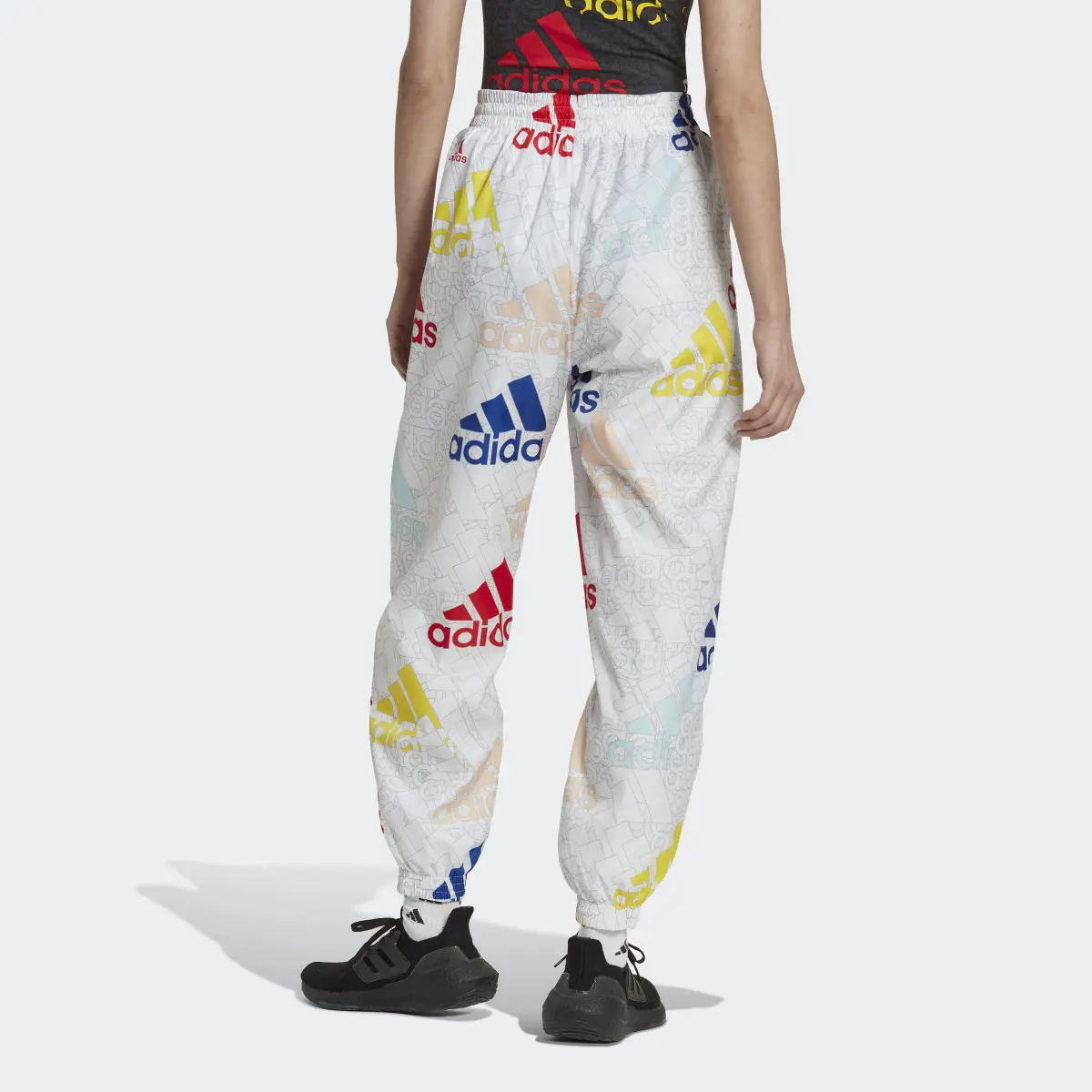 Adidas Essentials Multi-Colored Logo Loose Fit Woven Pants. 2