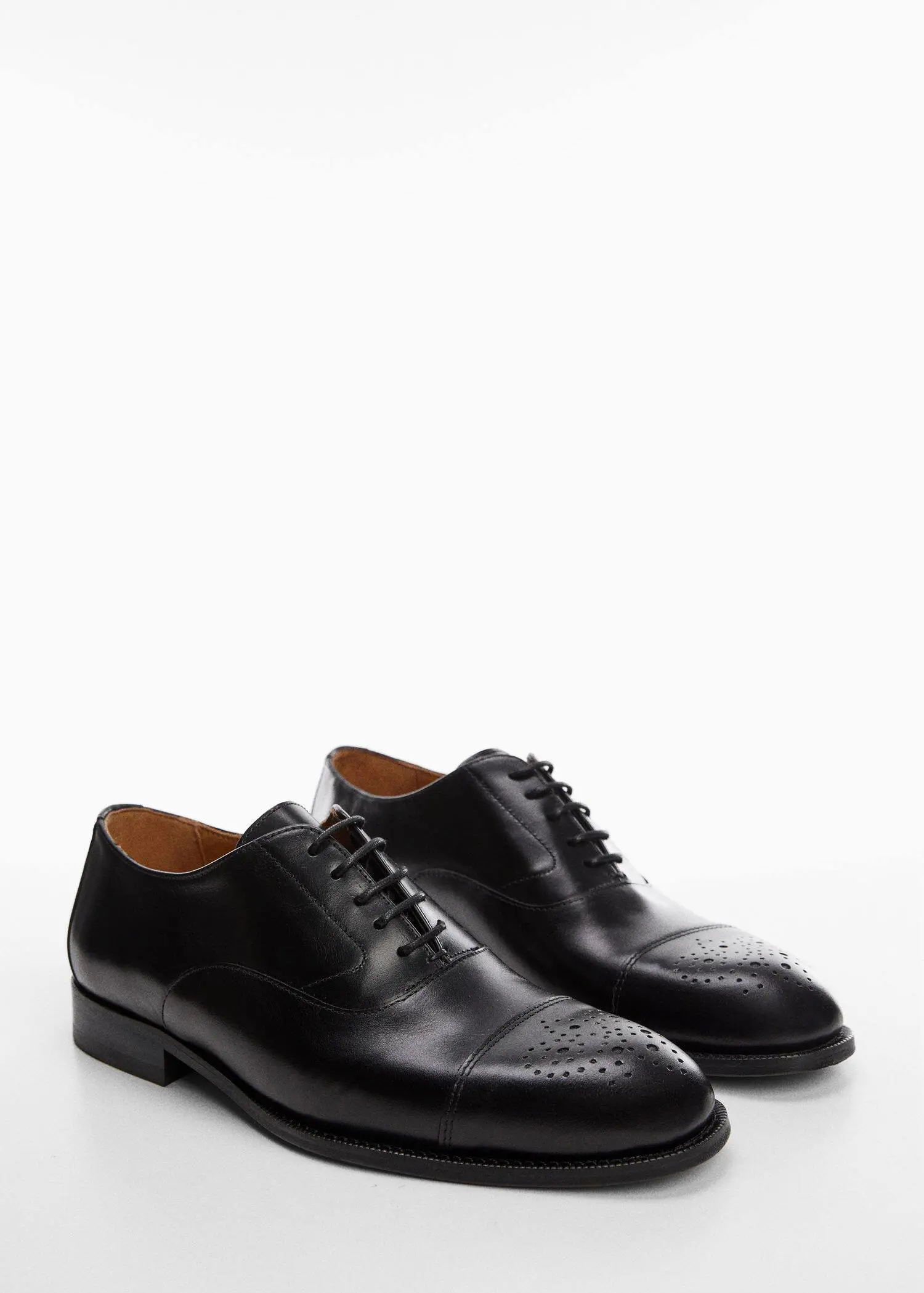 Mango Laser-cut leather blucher shoes. a pair of black dress shoes on a white surface. 