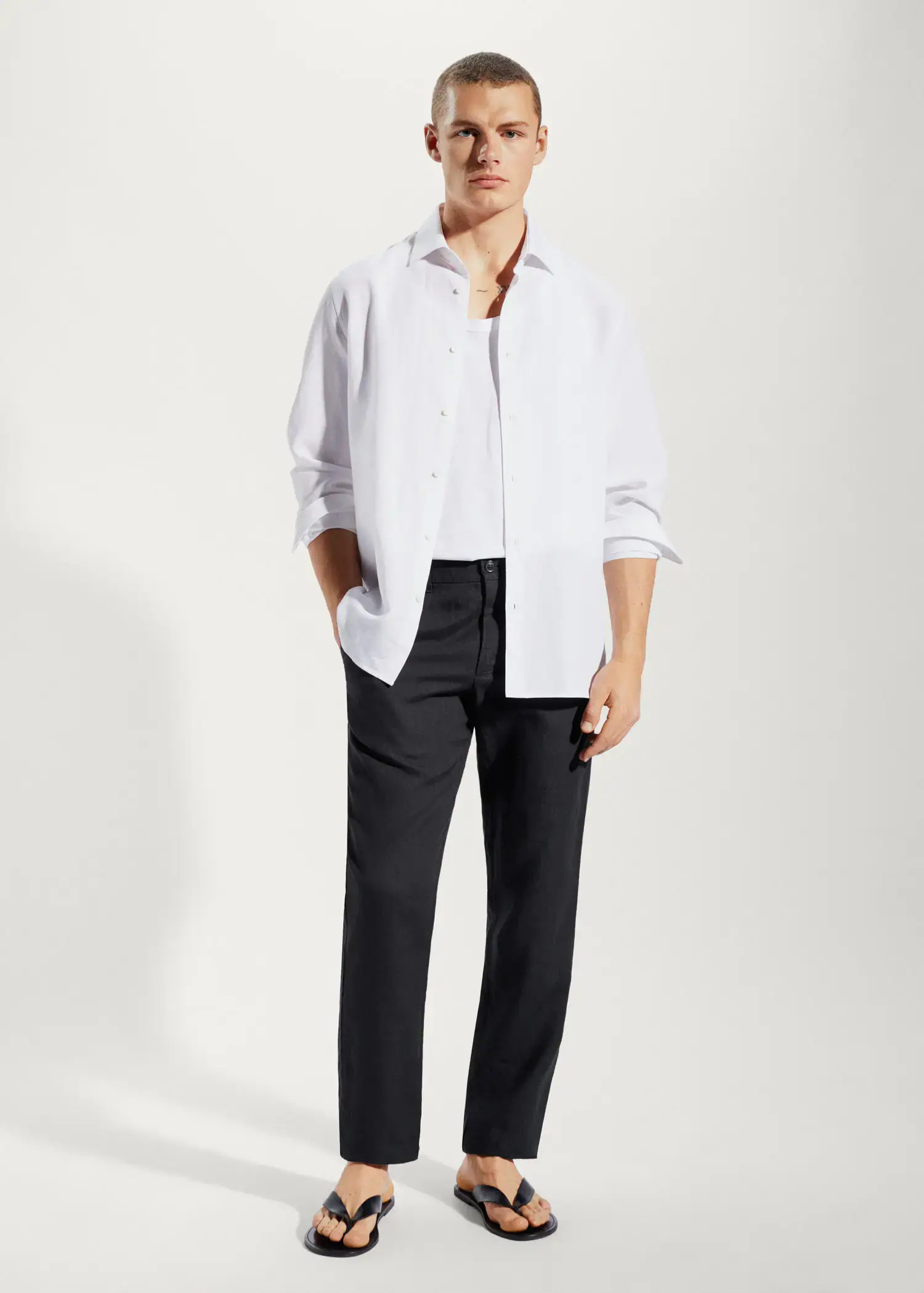 Mango Slim-fit 100% linen pants. a man wearing a white shirt and black pants. 