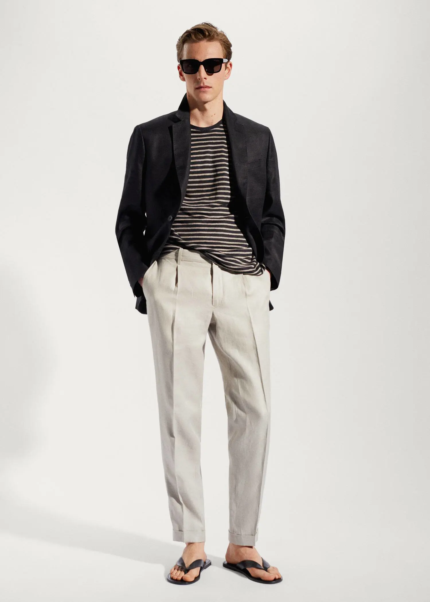 Mango 100% linen striped t-shirt. a man in a black jacket and white pants. 